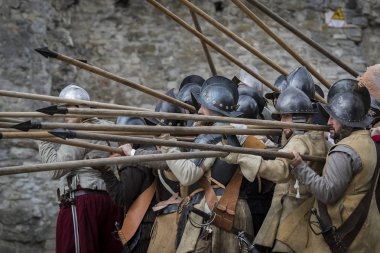 KAMYANETS-PODILSKY, UKRAINE - 21 SEPTEMBER , 2019: Historical military reconstruction of the Ukrainian and Polish troops of the seventeenth century in the castle of Kamyanets-Podilsky. clipart