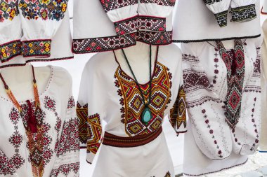 KIEV, UKRAINE - OCTOBER 4, 2019: Traditional Ukrainian clothing embroidered with colored womens in men's shirts of embroidered shirt. clipart