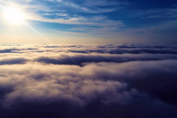 Flying over clouds. Fantastic landscape. Inspiration, Peace, Freedom, Overcoming, God. Great sky view! Aerial and panoramic view of a beautiful blue sky above clouds.