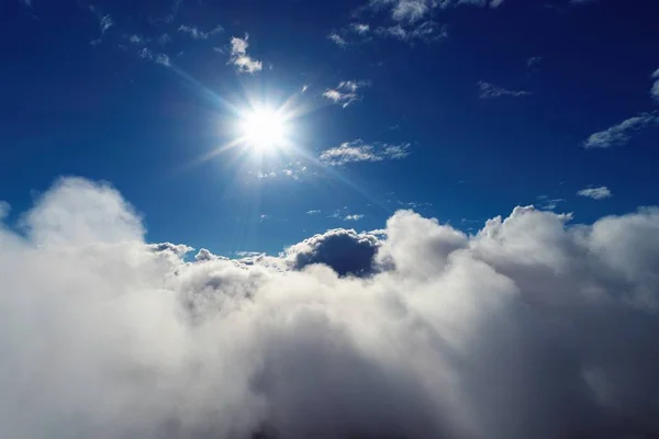 Flying over clouds. Fantastic landscape. Inspiration, Peace, Freedom, Overcoming, God. Great sky view! Aerial and panoramic view of a beautiful blue sky above clouds.