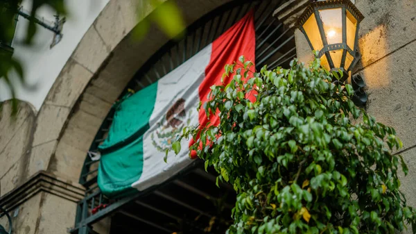 Mexican Flag Hanging Over a Building Arched Entrance — Stock Photo, Image