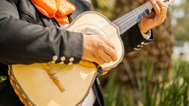 Mariachi sokaklarda Meksikalı Vihuela 'yı oynuyor.