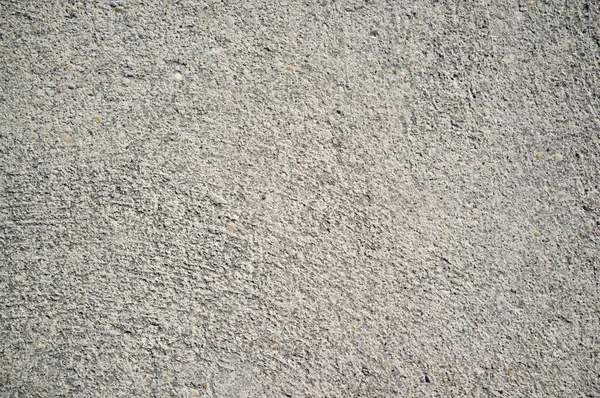 Chropowatość betonu ściana z małych, szare skały osadzone w powierzchni — Zdjęcie stockowe