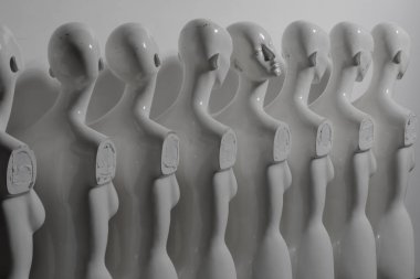 Greyish Picture of Plastic Woman Figurines Standing in The Line clipart