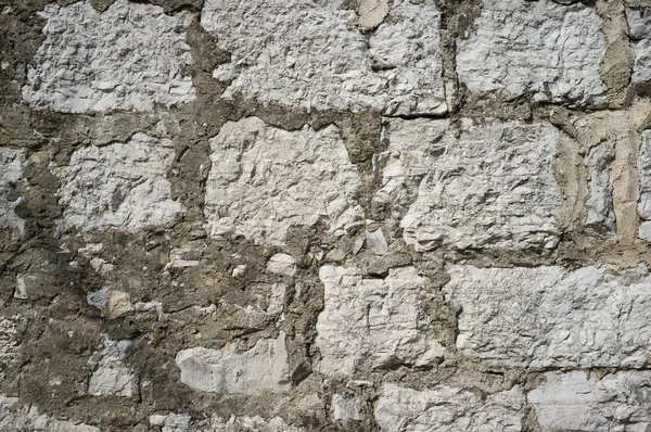 Alte grunzige und verwitterte Steinmauer — Stockfoto