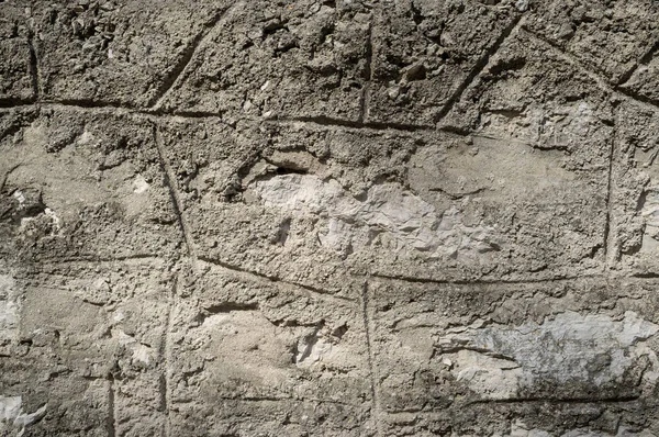 Старая Грэмми и вымотанная каменная стена — стоковое фото