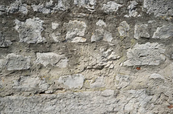 Alte grunzige und verwitterte Steinmauer — Stockfoto
