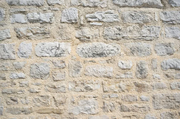 Alte grunzige und verwitterte Steinmauer — Stockfoto