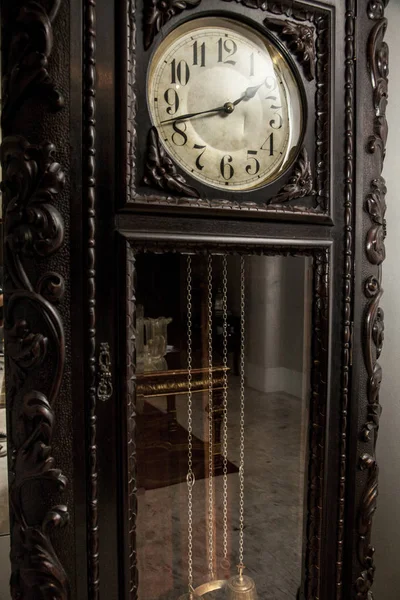 An old grandfather clock on a fancy room.