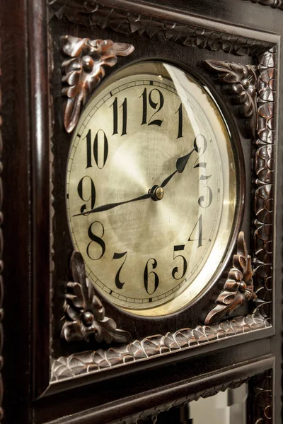 An old grandfather clock on a fancy room. Close up.