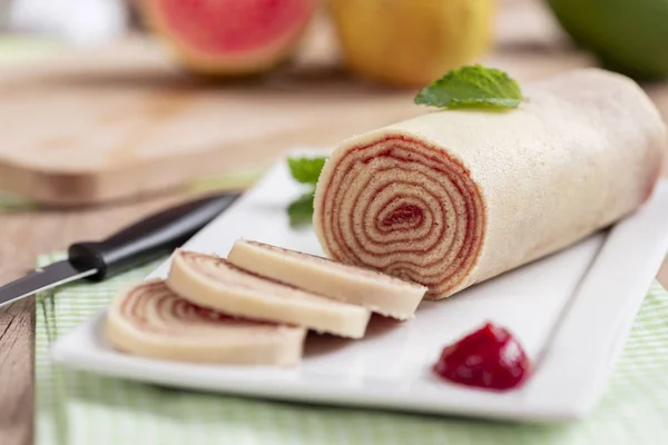 Bolo de rolo (swiss roll, roll cake) typical Brazilian dessert, from the state of Pernambuco. Sliced cake roll filled with Guava paste.