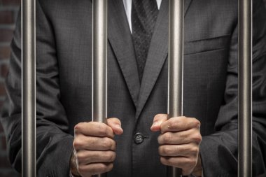 Brezilyalı adam para bir kelepçe ile faturalar bir hapiste tutan. yolsuzluk, yozlaşmış siyasetçiler, yasadışı işletmeler kavramı. tuğla arka plan.