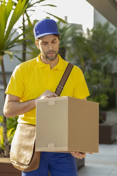 Brazilian mailman delivering a package.