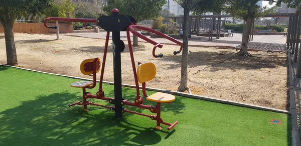 sports equipment for training for two people on green grass in outdoor gym at city park