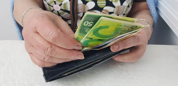 Oudere Vrouw Houdt Handen Israëlische Cash Geld Zwarte Oude Portemonnee Rechtenvrije Stockfoto's