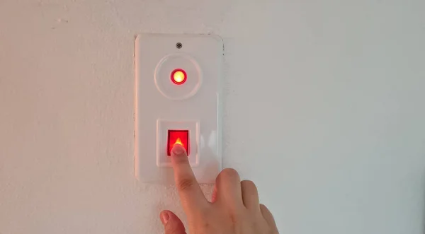 Female Finger Switches Red Light Button Wall — Stock Photo, Image