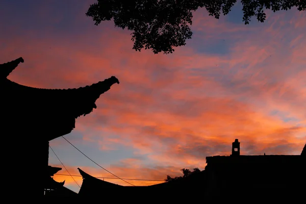 Clouds at sunset. An ancient stately home in the historic city center of Jianshui. Yunnan, China — Stock Photo, Image