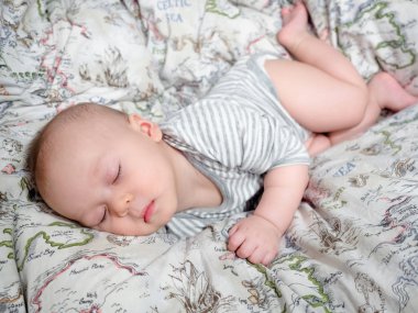 Mutlu uyuyan bebek 5 aylık yarım yarış Asya beyaz çocuk, sağlıklı çocuk bebek çocuk karışık. Yatakta yarı Tay yarım Lehçe