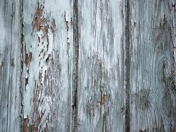 Old wooden pattern combined by boards and planks, rusty elements painted with blue paint. Textures, damaged pieces of an old gate — Stock Photo, Image