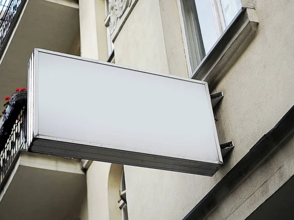 Rectangle, signboard side view of empty white mock up signage in white frame with old city wall background display exterior. Very modern shape — Stock Photo, Image