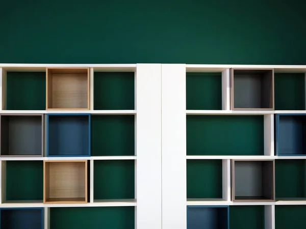 modern, empty white bookshelf with beautiful green wall, shelf