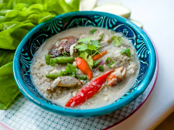 Salted crab stew with coconut milk, minced pork served with vegetables, Thai food. Salted Black Crab.