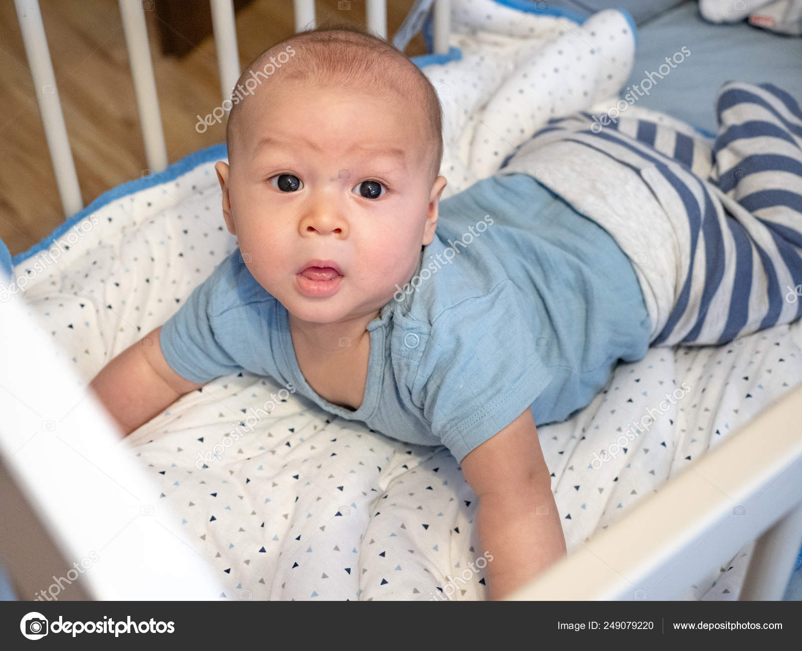 Cute 4 months old old race boy looking smiling and laughing at