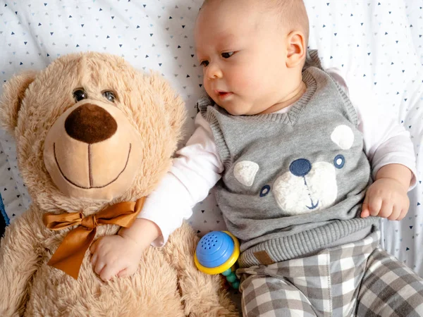 Happy baby with teddy bear Cute 4 months old mixed half race Asian Caucasian boy looking happy smiling and laughing at the camera, healthy child baby boy. Half Thai half Polish