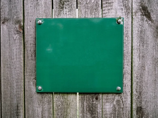 Green mock up empty information board, panel on a wooden planks background — Stock Photo, Image