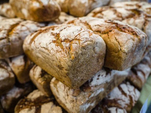 Homemade bread loaves. Fresh bread in bakery background and texture for banner image on website or print media design. Rye bread on market stall.