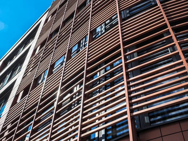 Poznan, Poland, 5 April 2018, Detail of an modern office building with blind and wooden facade — Stock Photo, Image