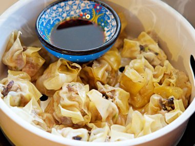 Hot and warm Shaomai is a type of traditional Chinese dumpling, Cantonese cuisine, consists of chopped or minced mutton, scallion and ginger (or Dim sum) with sauce clipart
