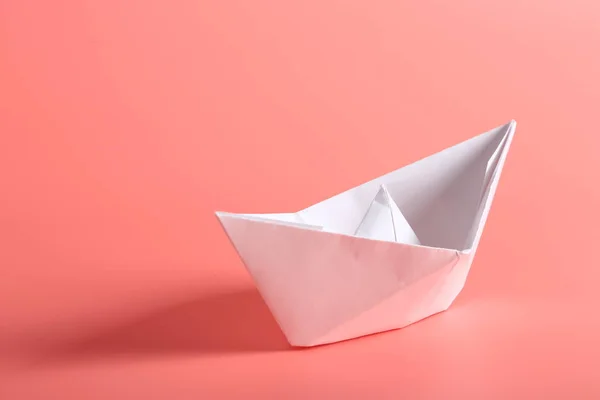 paper ship on a pink background.