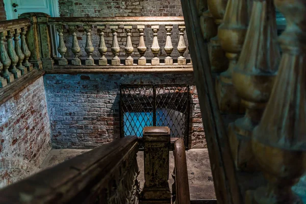 Wooden staircase in an old house, authentic setting, wooden carved columns for railing