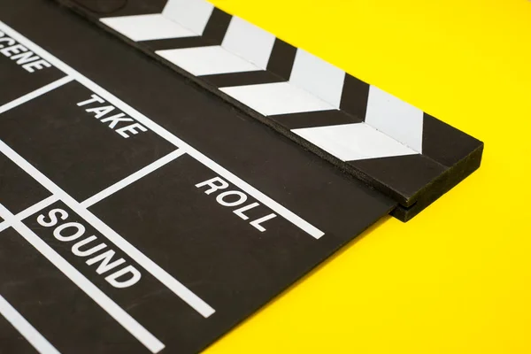 Movie clapper on a yellow background