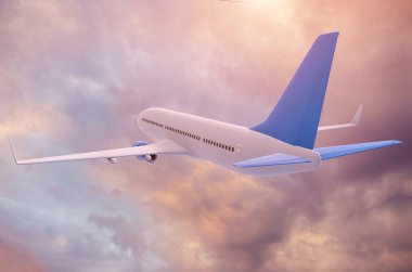 Uçak günbatımı bulutlarının arka planında uçar