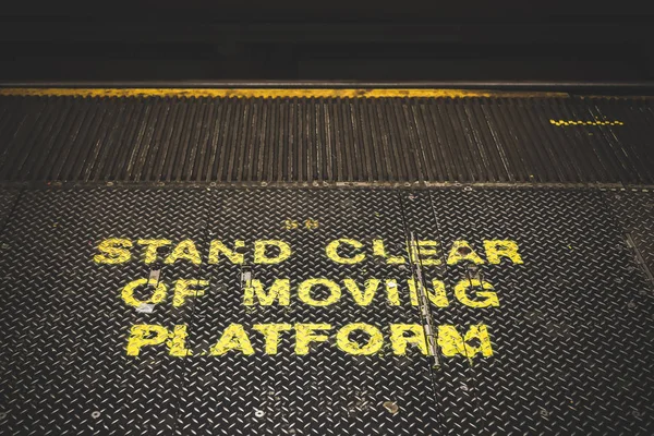 Stand clear of moving platform lettering in subway