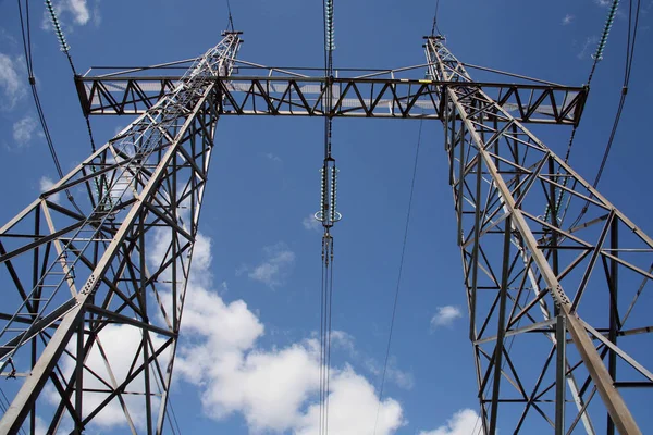 Bottom view of power lines against sky