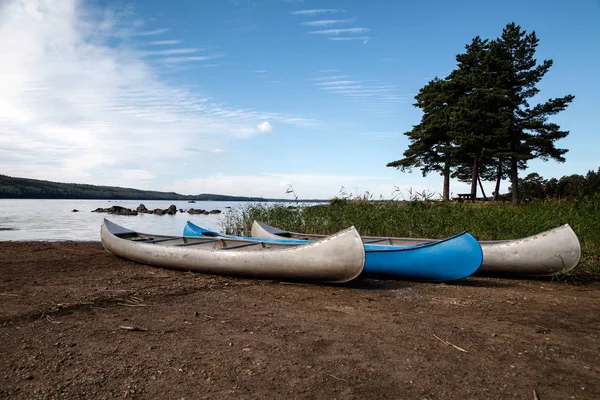 Canoes placed in row near river