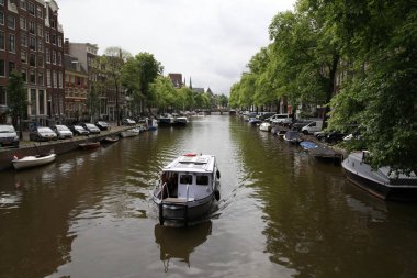 Hollanda 'da Amsterdam kanalda insanlarla tekne 