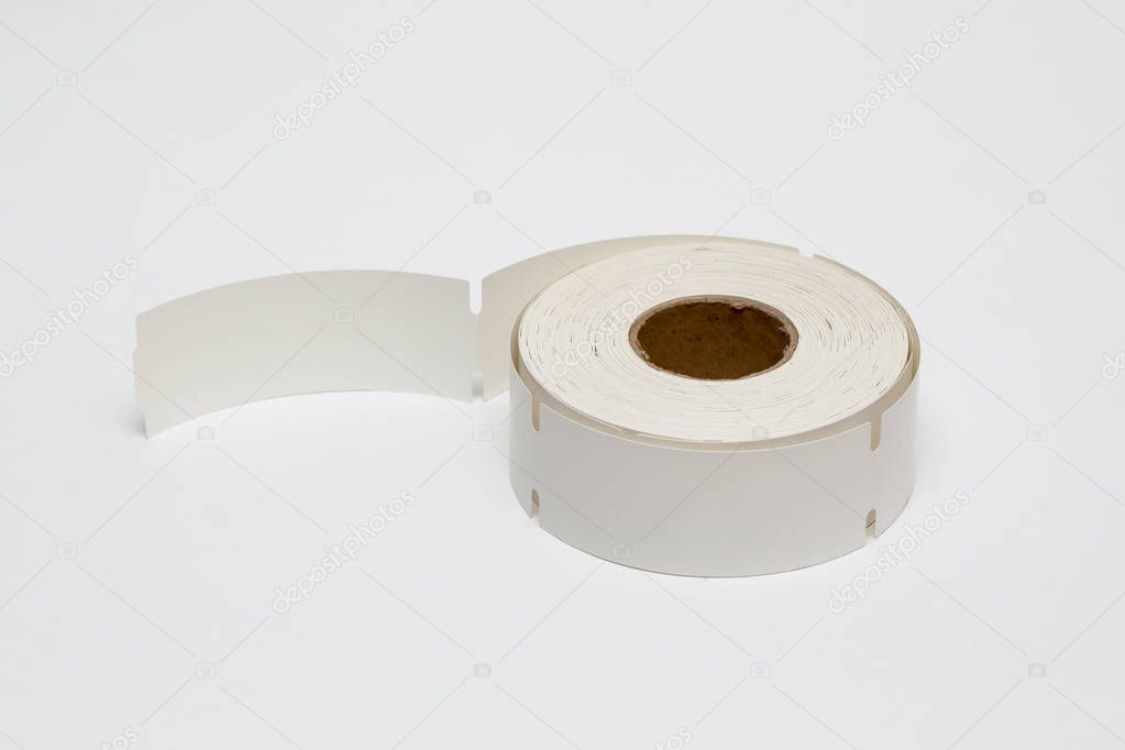 Roll of cash register tape isolated on soft gray background.High resolution photo.