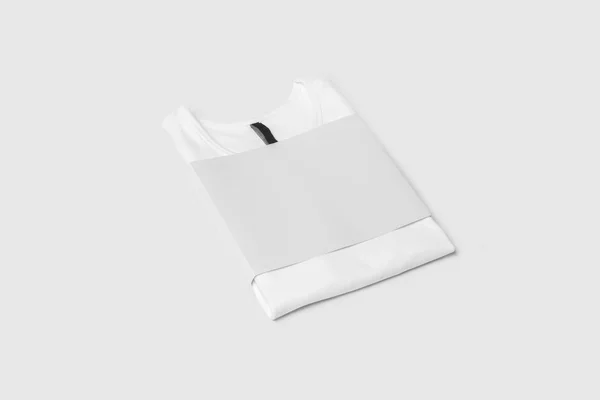 Folded Blank White T-Shirt Mock-up on soft gray background, front view. Ready to replace your design.
