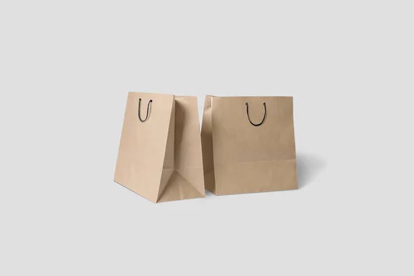 棕色纸购物袋模型隔离在软灰色背景 — 图库照片