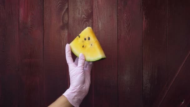 Female hand holds a watermelon slice — Stock Video