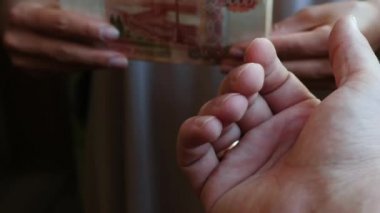 Tanınmaz bir kadın Rus ruble bir wad verir