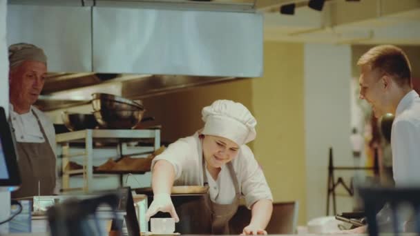 Cocina del restaurante. Chef y camarero sonriendo y sirve platos — Vídeos de Stock