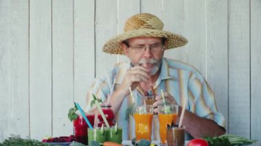 Yaşlı adam çeşitli smoothies tadı