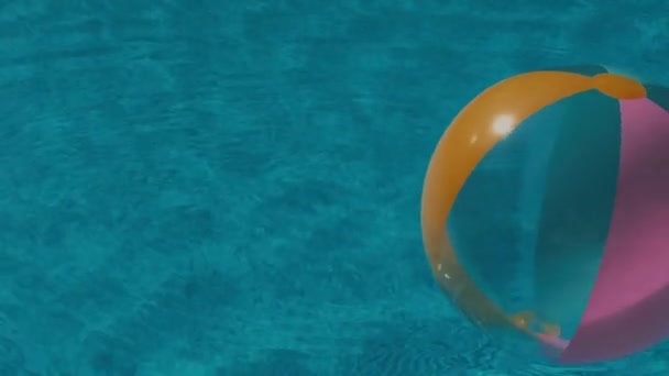Colorful ball floats in the pool — Stock Video