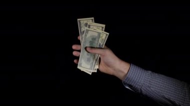 Erkek eli dolar banknotlarını buruşturup atıyor.