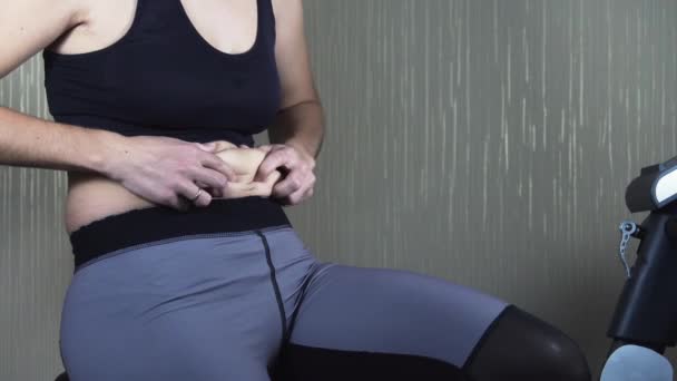 Woman examines the folds on her stomach — Stock Footage Woman examines the folds on her stomach Royalty Free Stock Footage